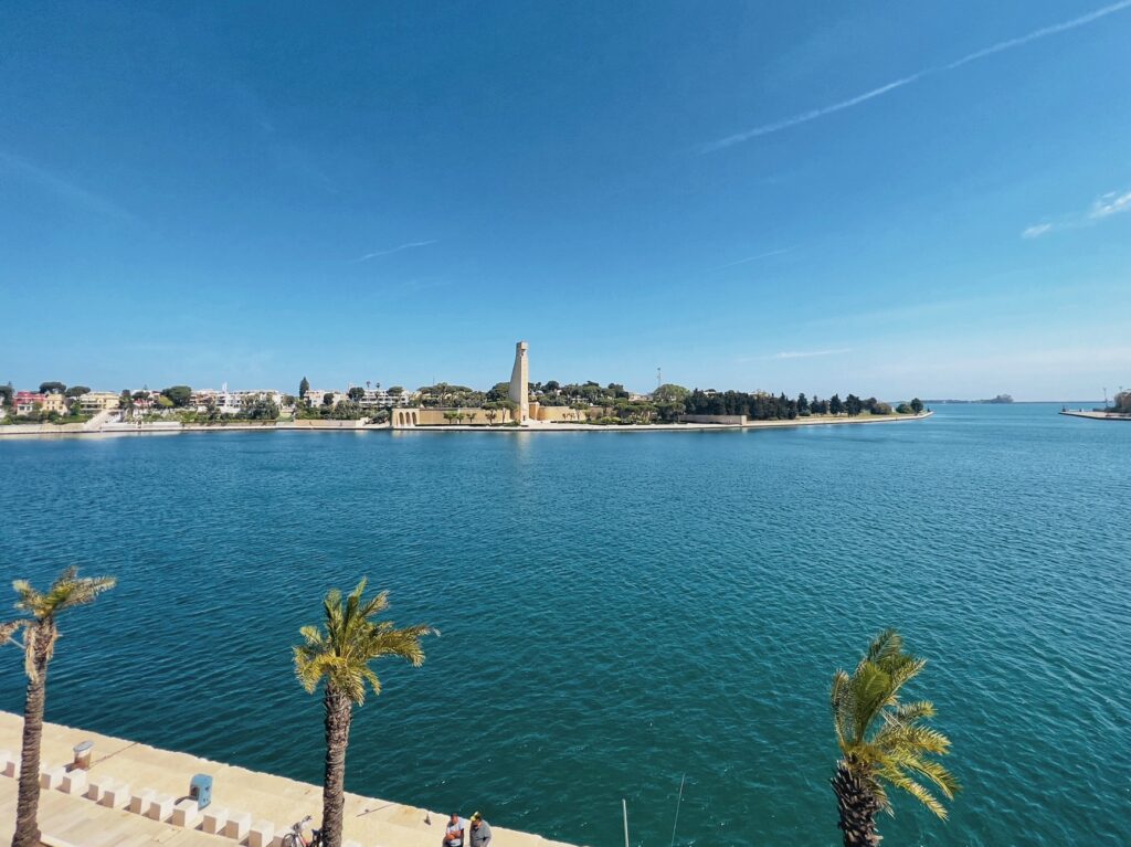 Brindisi lungomare with the Monument to the Italian Sailor in the background | Photo © the Puglia Guys for the Big Gay Podcast from Puglia, city guides and guides to Puglia’s best restaurants, accommodation and things to to in Puglia, Italy’s top gay summer destination for LGBT travel.