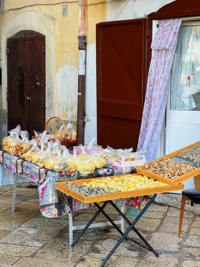 Orecchiette, troccoli, cavateli: in Strada Arco Basso, the heart of old Bari, watch the famous Bari ladies who prepare and sell fresh pasta on their doorstep. These ‘nonne’ have transitioned from tradition into legend! Photo copyright ©️ the Puglia Guys.