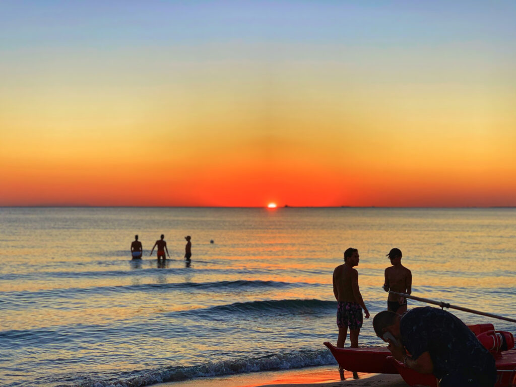 Surviving Italy’s Caronte Heat Storm: Top Tips to Stay Cool And Enjoy Your Summer - make your own shade. Photo by the Puglia Guys. Por do Sol. Baia Verde, Gallipoli.