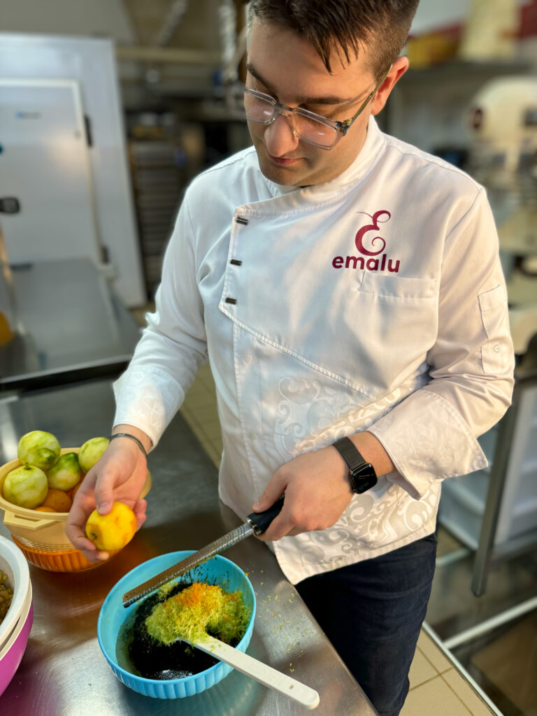 Grating the rind of lemons and oranges for Panettone - traditional and three chocolate artisan panettone from Emalu pasticceria in Puglia. From the Puglia Guys Guide to Panettone, Italy’s traditional Christmas cake. Eat Puglia with the Puglia Guys.