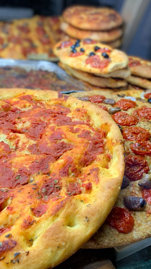 Focaccia bread baked at the panificio in Puglia. Add value to your Puglia vacation by discovering authentic Puglia, by the Puglia Guys.