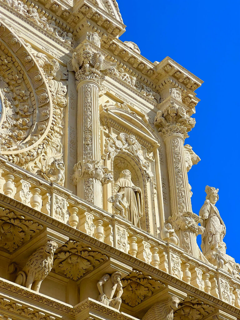 the astonishing Basilica of Santa Croce. Take your time to contemplate its facade, only recently revealed after years of restoration works. The detail - made possible by the soft Lecce limestone - is astonishing. Flowers, fruits, cherubs, mythical figures, animals and sculpted figures almost seem to form an external altar. Photo the Puglia Guys for the Lecce Guide