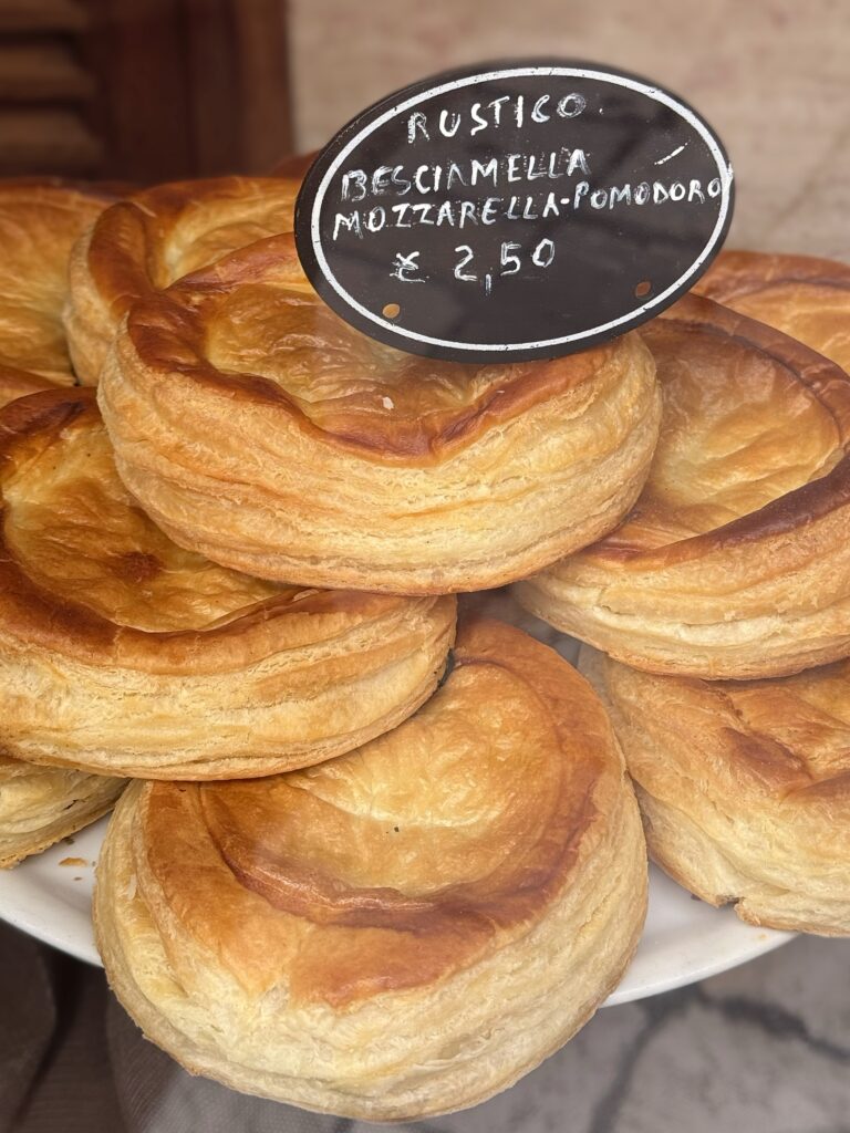 When in Lecce, try a rustico leccese. Flaky pastry with béchamel mozzarella and tomato filling. A traditional breakfast pastry from Lecce, Puglia, eaten across Salento and Puglia. Photograph by the Puglia Guys, Puglia ambassadors, for the Puglia Guys Lecce guide. PugliaGuys.com