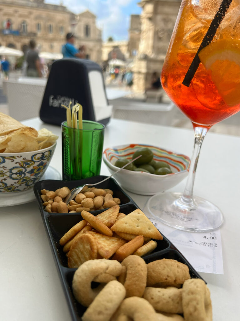 Aperitivo at Caffè Fanelli Bistrot, Ostuni. The best value aperol spritz on Ostuni’s piazza. Photo the Puglia Guys from the Puglia Guys Ostuni Guide.